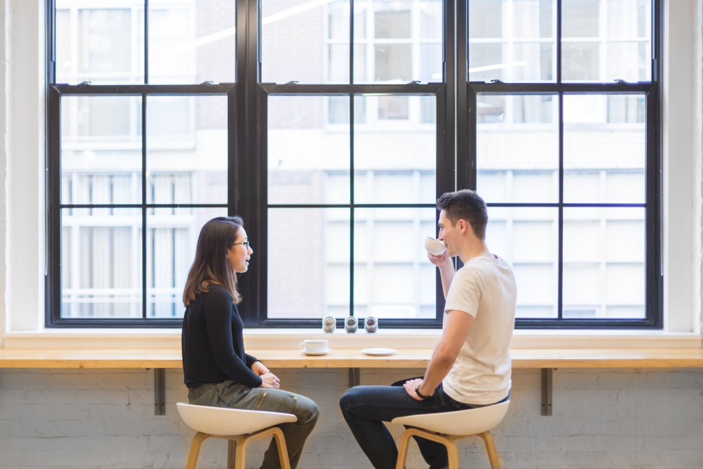 Two individuals chatting about business